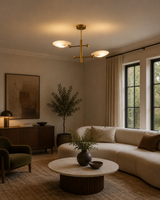 Luna 2 light sculptural disc chandelier installed in a warm modern living room with white shades illuminated, Model 62015