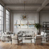 Madrid 10 light sculptural starburst chandelier shown from an alternate angle highlighting its black radial rods and warm brass-tone central hub.