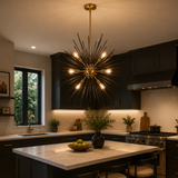 Madrid 10 light black and brass-tone Sputnik chandelier illuminated above a kitchen island in a sophisticated contemporary interior.