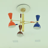 Manhattan mid-century modern Sputnik chandelier with orange, cobalt blue, and brown metal shades, brass-tone multi-arm frame, ceiling-mounted unlit view.