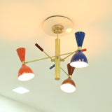 Manhattan retro Sputnik chandelier featuring illuminated orange, blue, and brown double-cone metal shades with warm lighting and brass-tone frame.