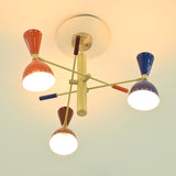 Close-up of Manhattan mid-century chandelier with glossy multicolor metal shades, perforated detailing, and warm glowing bulbs.