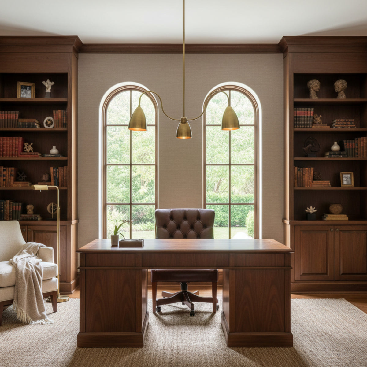 Close-up view of Marbella 3 light chandelier highlighting aged brass cone shades and gracefully curved arms.