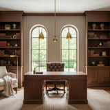 Close-up view of Marbella 3 light chandelier highlighting aged brass cone shades and gracefully curved arms.