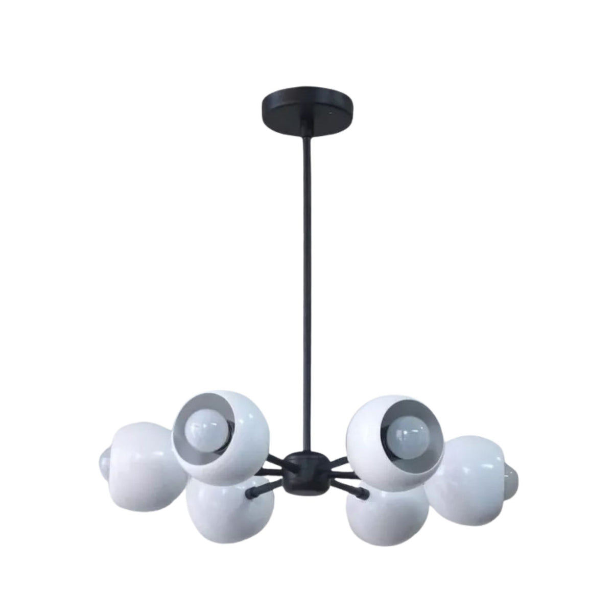 Marbella 6 light sculptural chandelier shown from the front with rounded white dome shades, visible bulbs, and a black metal frame.