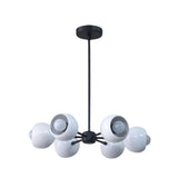 Marbella 6 light sculptural chandelier shown from the front with rounded white dome shades, visible bulbs, and a black metal frame.