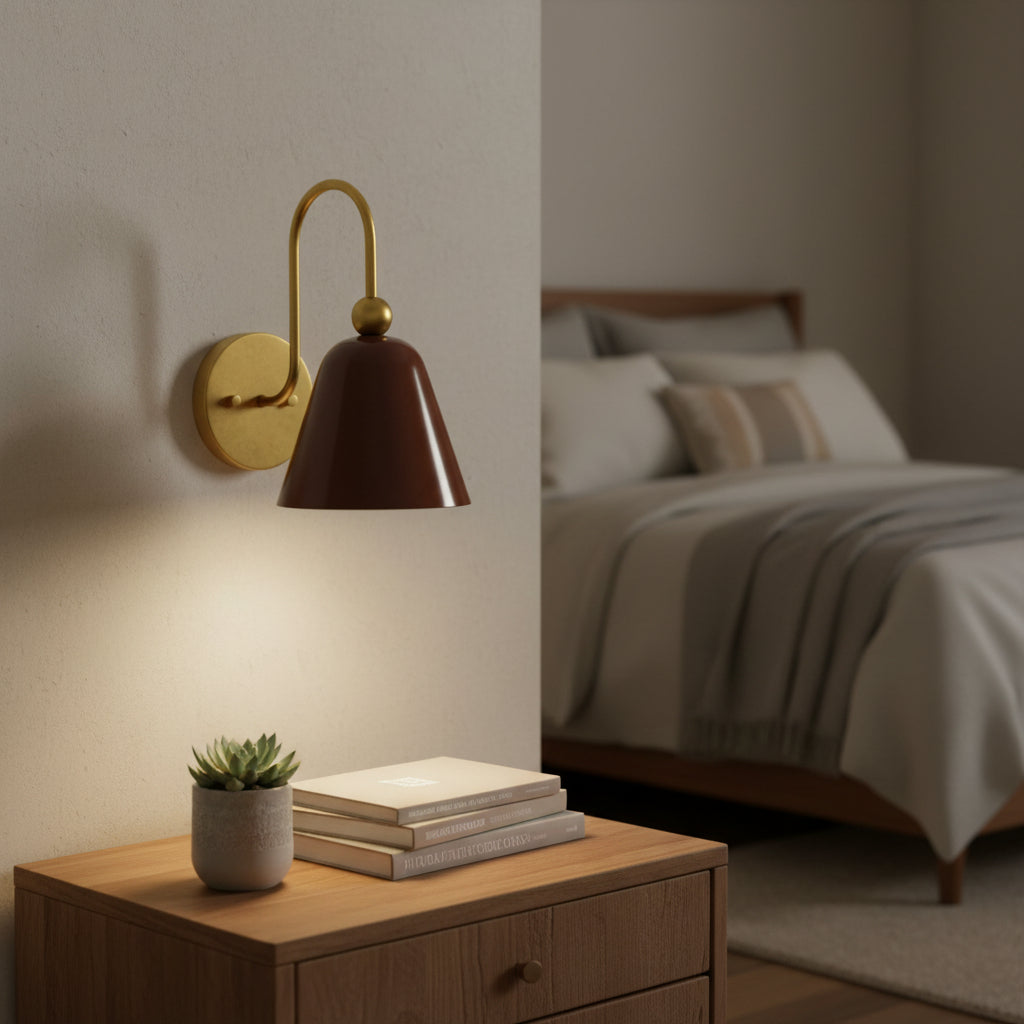 Angled view of Marlow bell shade wall sconce with warm brass curved arm and brown metal shade – Model 32809