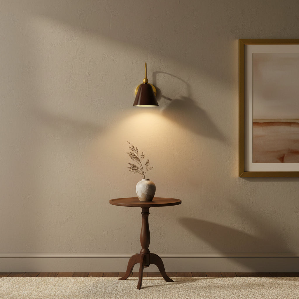 Marlow wall sconce featuring a dark bell-shaped metal shade, curved brass arm and round wall canopy – Model 32809