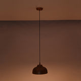 Marlow hammered copper dome pendant light suspended in a dark setting with soft ambient illumination emphasizing the handcrafted copper finish.