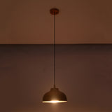 Marlow hammered copper dome pendant light emitting focused warm downward light from its handcrafted hammered copper shade.