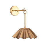 Angled view of the Marlow Modern Pleated Flower Wall Sconce featuring a handcrafted pleated flower-inspired metal shade with a frosted opal glass globe and decorative hanging ring.