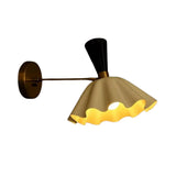 Marlow brass scalloped dome wall sconce with black tapered accent shown illuminated from an angled view – Model 32826