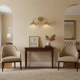 Front view of Marlow double wall sconce with two scalloped brass shades, curved arms and round wall canopy.