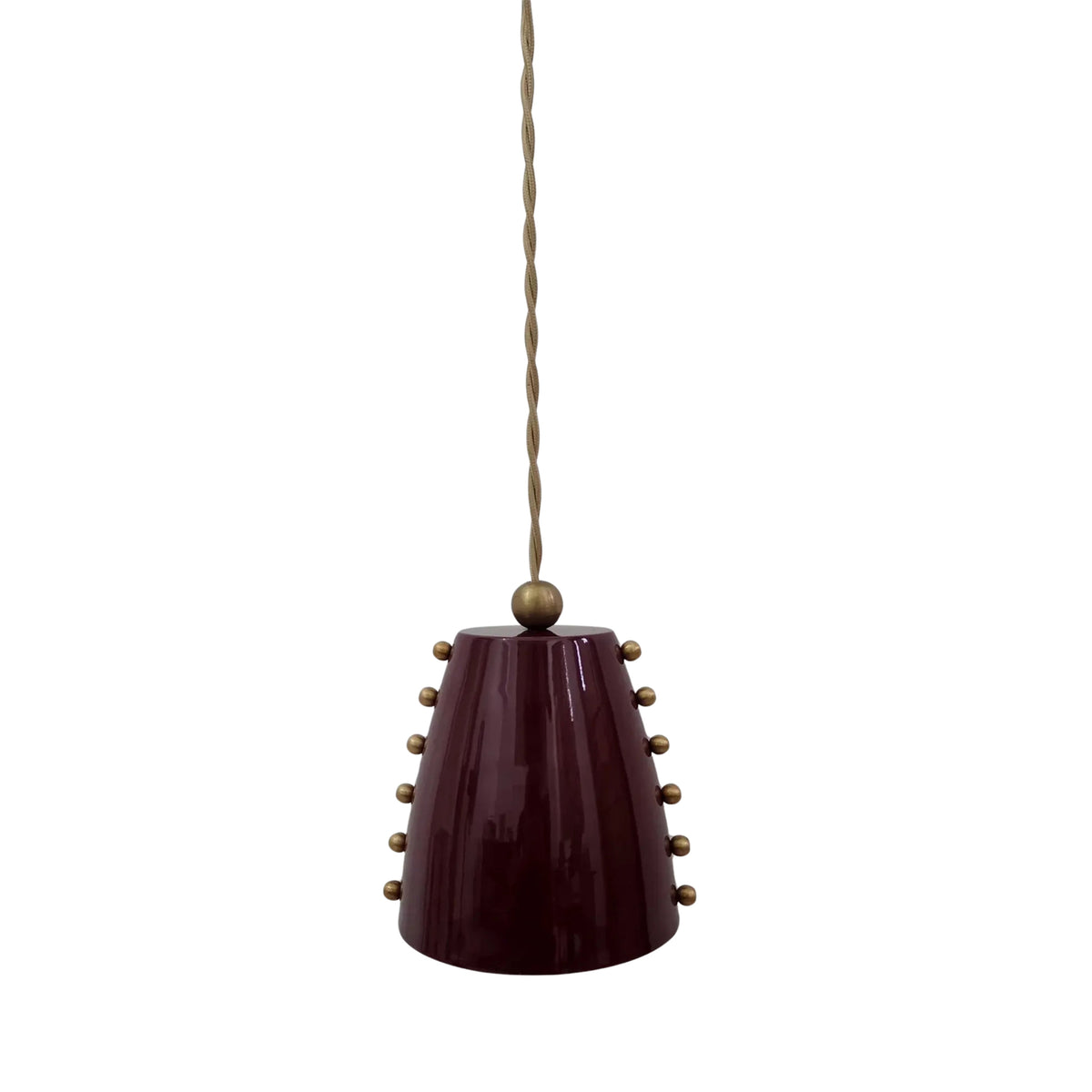 Angled front view of the Marlow pendant light highlighting its glossy burgundy cone shade, brass stud detailing, and elegant minimalist silhouette.