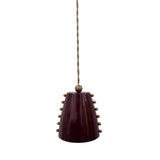 Angled front view of the Marlow pendant light highlighting its glossy burgundy cone shade, brass stud detailing, and elegant minimalist silhouette.