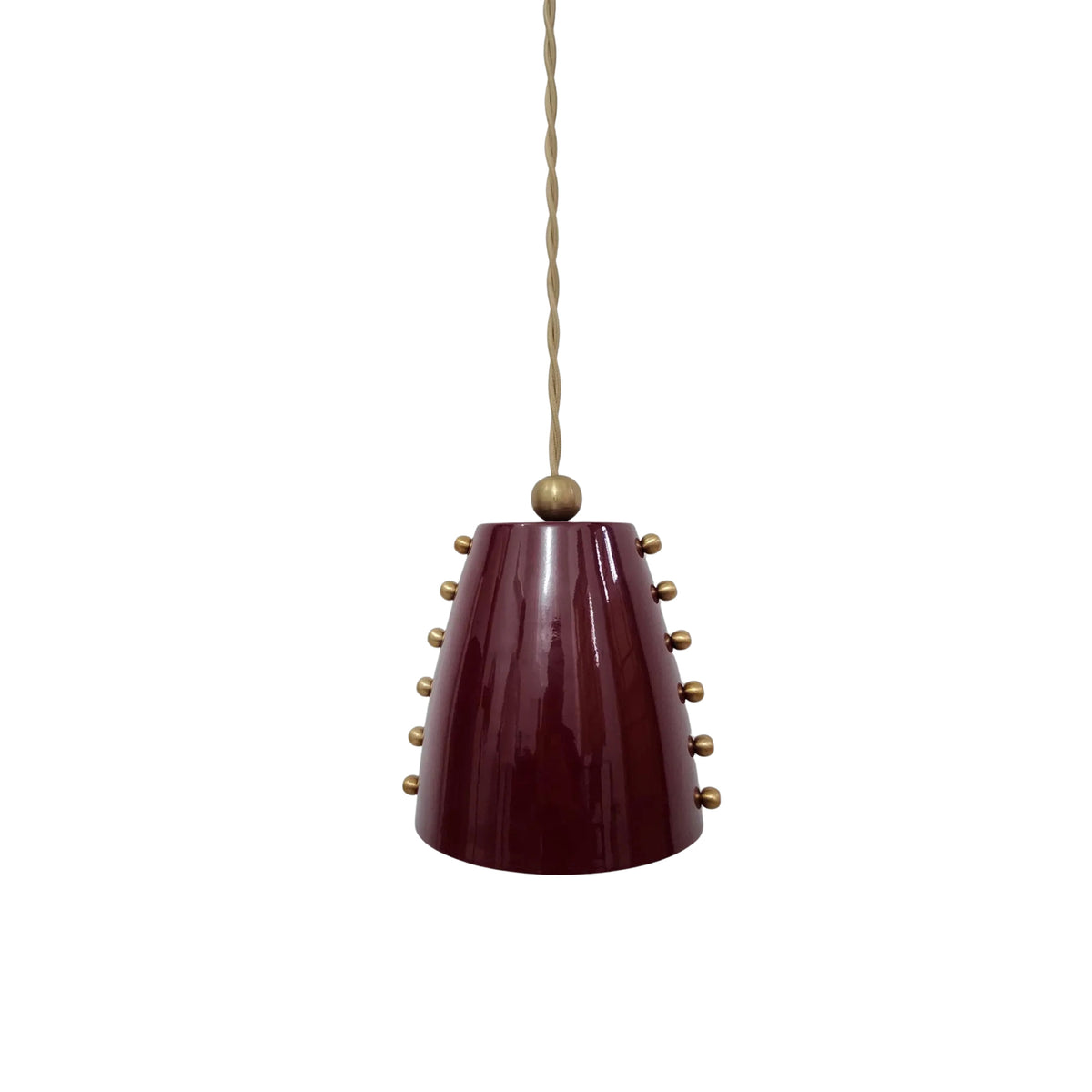Perspective view of the Marlow 5-inch pendant light with a tapered burgundy metal shade, brass stud accents, and an adjustable twisted fabric cord.