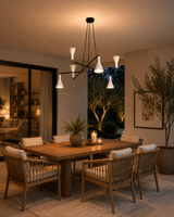 Marseille 6 light black and white chandelier displayed above a refined covered patio dining table with warm evening lighting.