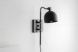 Matte black swing arm wall sconce with dome shade and adjustable arm, modern industrial wall lamp on square backplate