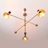 Angled side view of 6 light mid-century brass chandelier with black perforated cone shades