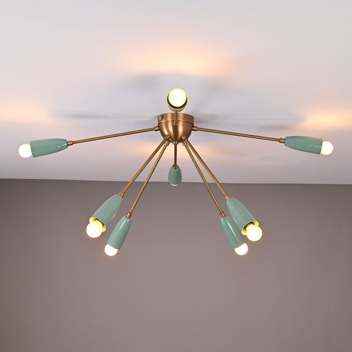 Mid-century 8-light brass ceiling chandelier with mint enamel shades illuminated