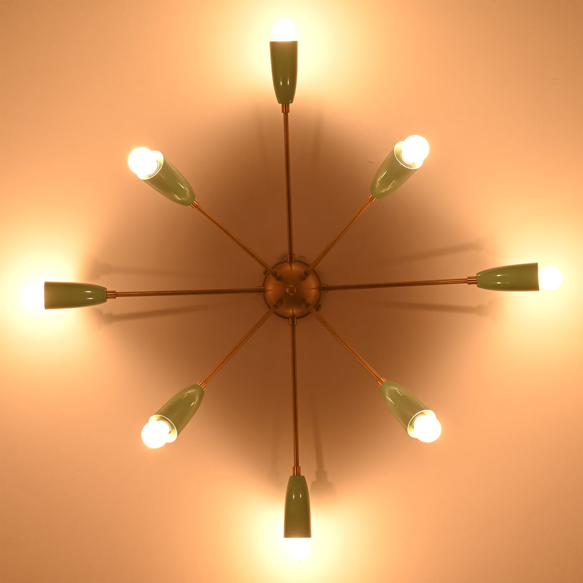 Warm-lit 8-light mint cone starburst chandelier viewed from below