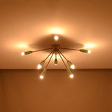 Modern mint and brass flush mount chandelier glowing warmly – room view