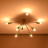 Starburst mint cone chandelier warm-lit from below on ceiling