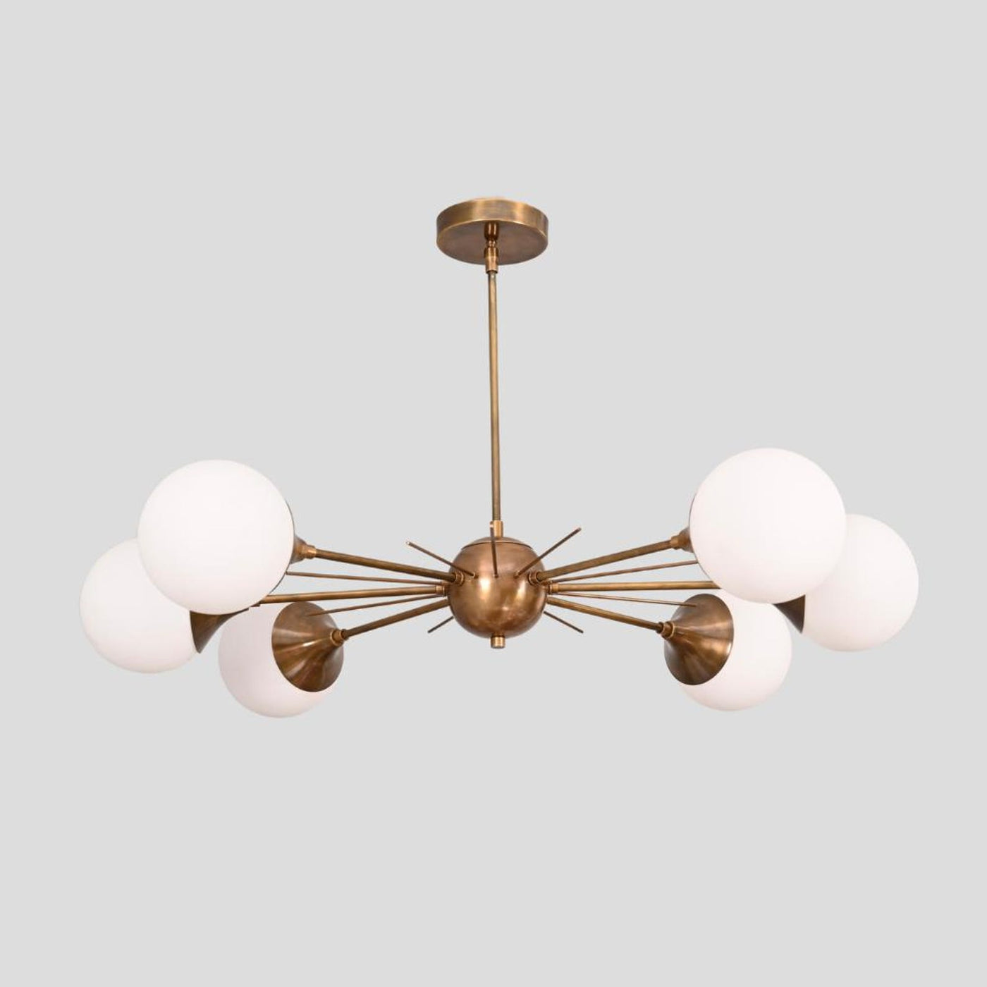 Handmade brass Sputnik chandelier with six white globe shades, radiating arms, and brushed brass finish, perfect for dining rooms and living areas.