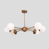 Handmade brass Sputnik chandelier with six white globe shades, radiating arms, and brushed brass finish, perfect for dining rooms and living areas.