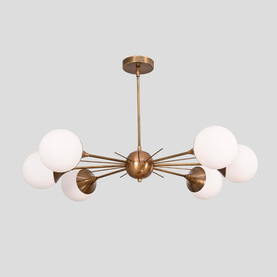 Handmade brass Sputnik chandelier with six white globe shades, radiating arms, and brushed brass finish, perfect for dining rooms and living areas.