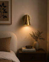 Milan perforated brass cone wall sconce installed beside bed with warm ambient lighting – Model 32771