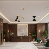 Angled view of Milan 8-light chandelier with black tapered cone shades and warm brass frame.
