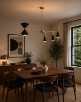 Milan black and brass 8-light sculptural chandelier displayed above a Mid-Century Modern dining table.