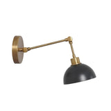 Milan adjustable dome wall sconce with brass articulated arm and dark metal shade, angled view