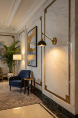 Milan Mid-Century adjustable dome wall sconce with brass arm and dark metal shade on white background