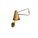 Front angled view of the Milan Adjustable Swing Arm Wall Sconce featuring a handcrafted tapered brass cone shade with an adjustable geometric swing arm.