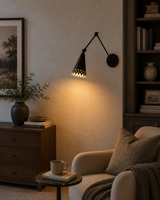 Milan adjustable swing arm wall sconce installed beside a reading chair with warm directional lighting in a cozy modern interior, Model 32784.