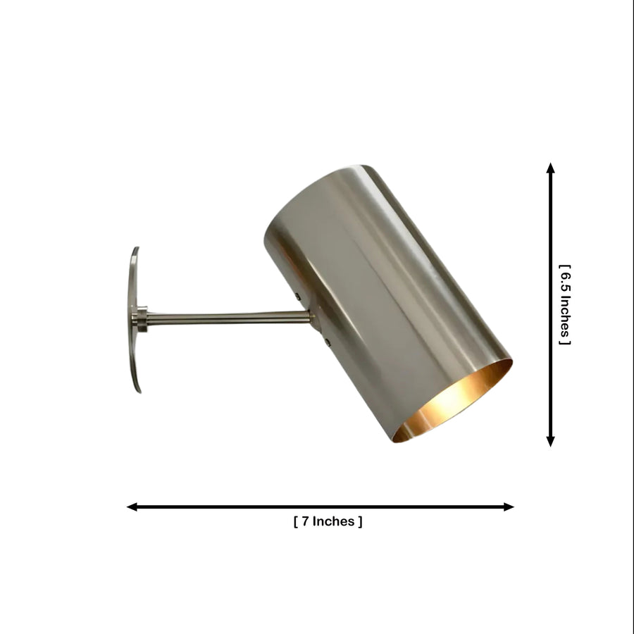 Milan angled cylinder wall sconce providing warm accent lighting in a modern reading and living room interior, Model 32752