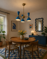 Milan Azure 6 light blue chandelier displayed above a wooden dining table in a Mid-Century Modern dining room.