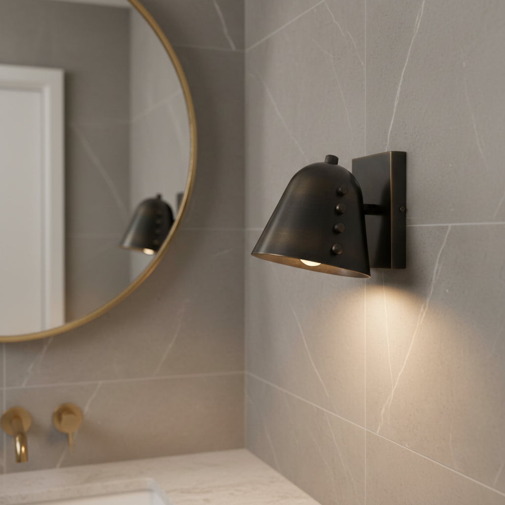 Side detail view of Milan black dome wall sconce with decorative studs and compact square backplate