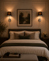 Milan black shade chrome wall sconces installed beside a bed in a warm classic bedroom setting.