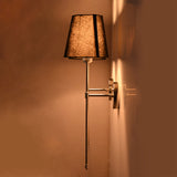 Side view of Milan black shade chrome wall sconce showing slim projection and warm shade lighting.