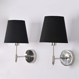 Angled view of Milan polished chrome wall sconce featuring a black tapered fabric shade, solid brass construction, and contemporary wall-mounted design.