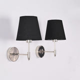 Side angle view of Milan polished chrome wall light with black fabric shade highlighting the slim wall arm and round chrome backplate.