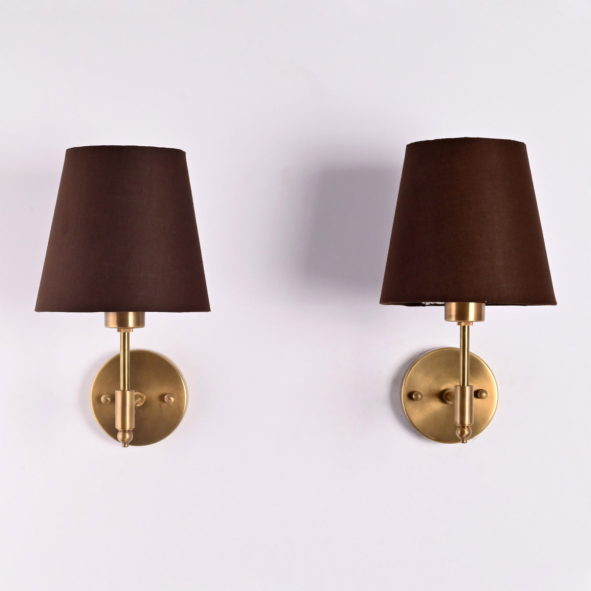 Front view of Milan Brown Shade Antique Brass Short Wall Sconce with tapered brown fabric shade and round brass backplate.