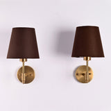 Front view of Milan Brown Shade Antique Brass Short Wall Sconce with tapered brown fabric shade and round brass backplate.