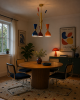 Milan Colorburst 6 light chandelier installed above a dining table in a Mid-Century Modern dining room with warm ambient lighting.