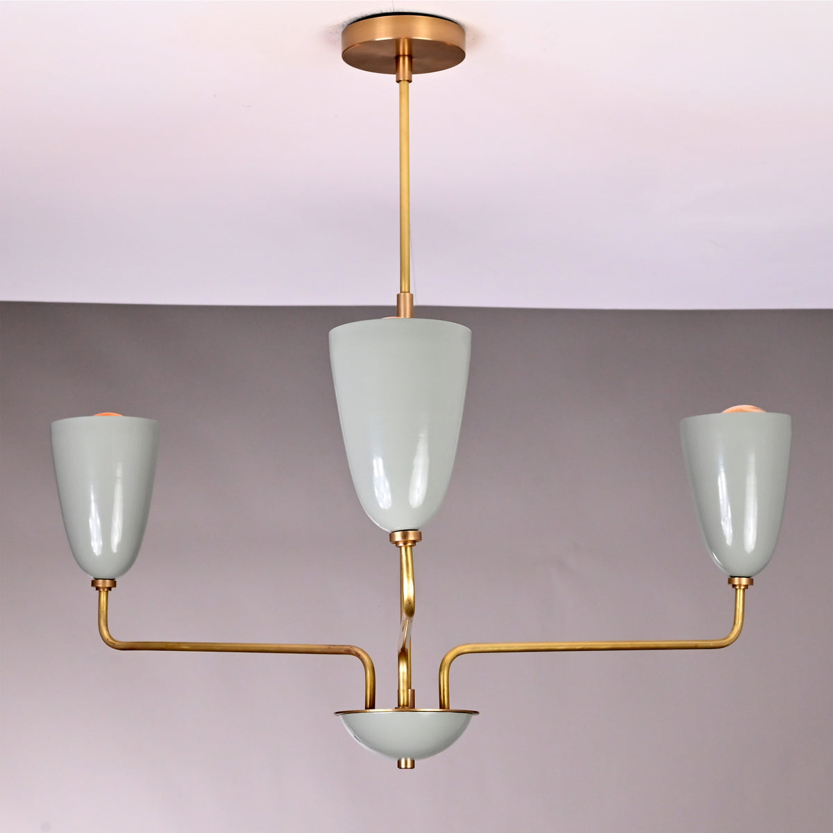 Close up of Milan Cone Arm Chandelier highlighting glossy cone shades, curved arms, and slim ceiling stem.