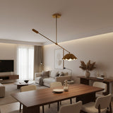 Milan counterbalance pendant light with pleated dome shade and elongated balancing arm in brass finish, angled view.
