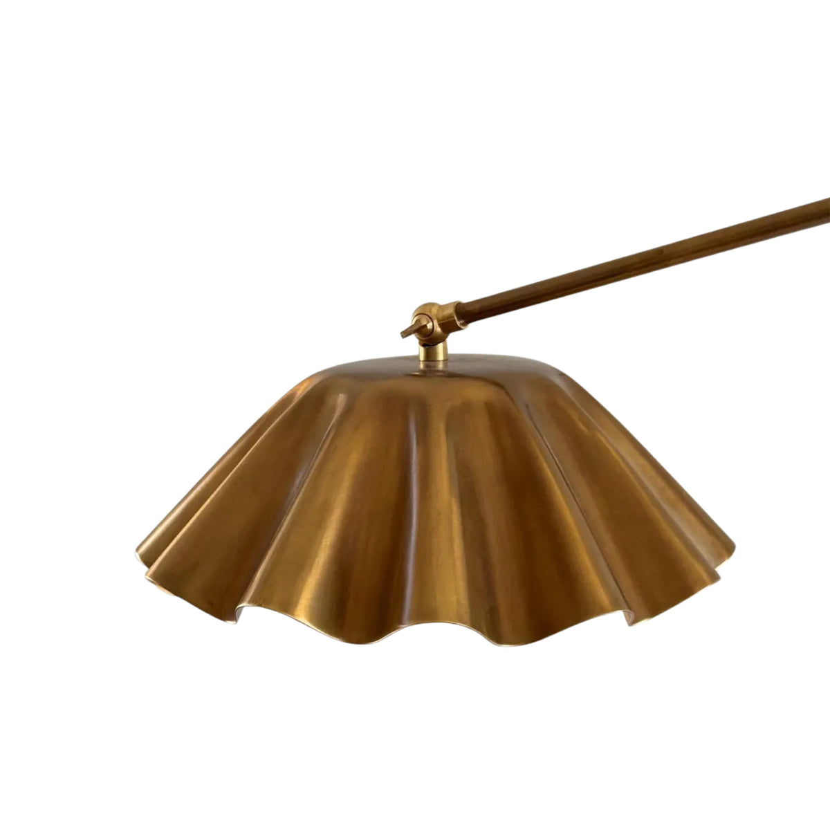 Close-up of Milan pendant pleated dome metal shade and adjustable arm connection in brass finish.